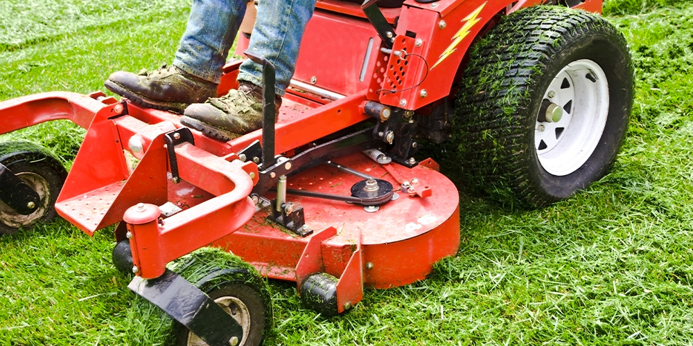 Photo Of A Man Using A Red Lawn Mower